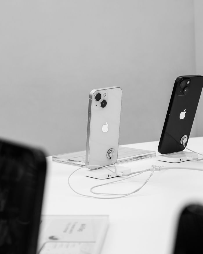 Home Black and white display of modern smartphones in a store setting, showcasing technology.