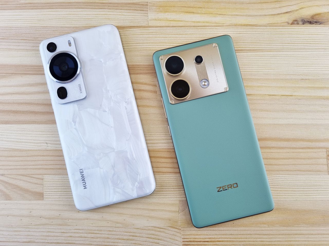 Home Close-up of two modern smartphones on a wooden table, contrasting designs and colors.